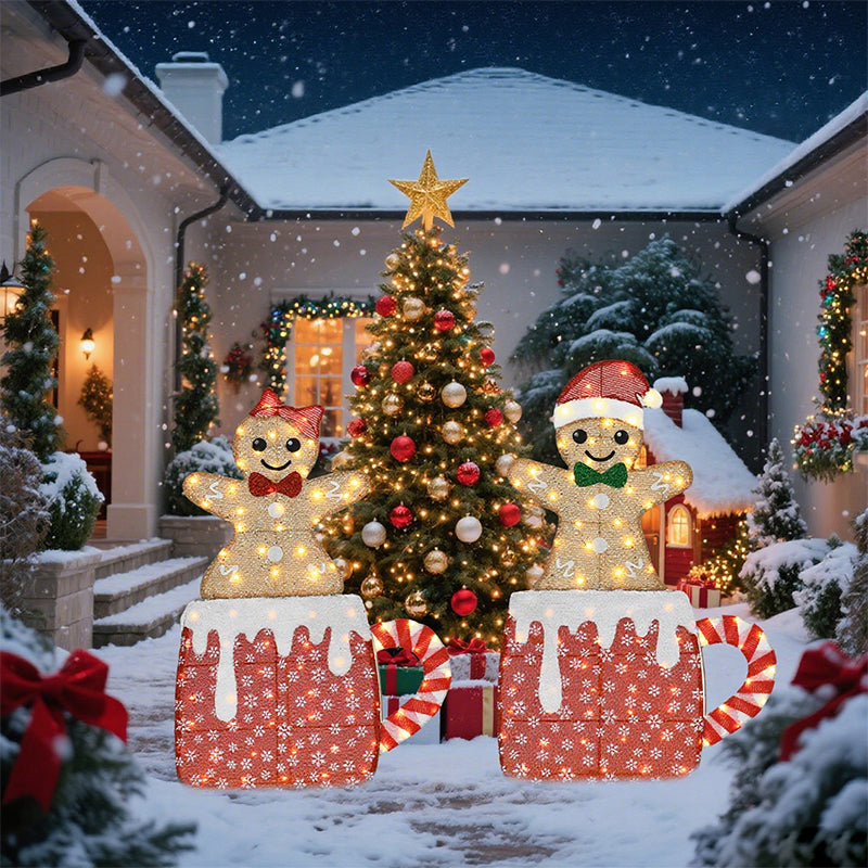 40" Set of 2 lighted 2D tinsel gingerbread couple decorations, featuring cute gingerbread figures sitting inside festive Christmas mugs, plug-in powered with warm glowing lights.