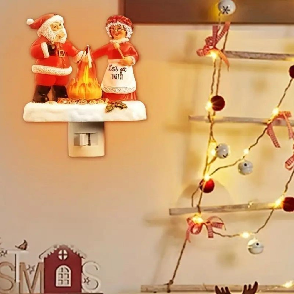 Christmas Plug-in Night Light Santa and Mrs Claus Roasting Marshmallow by Campfire Flickering Flame Resin Figurine Wall Sconce.