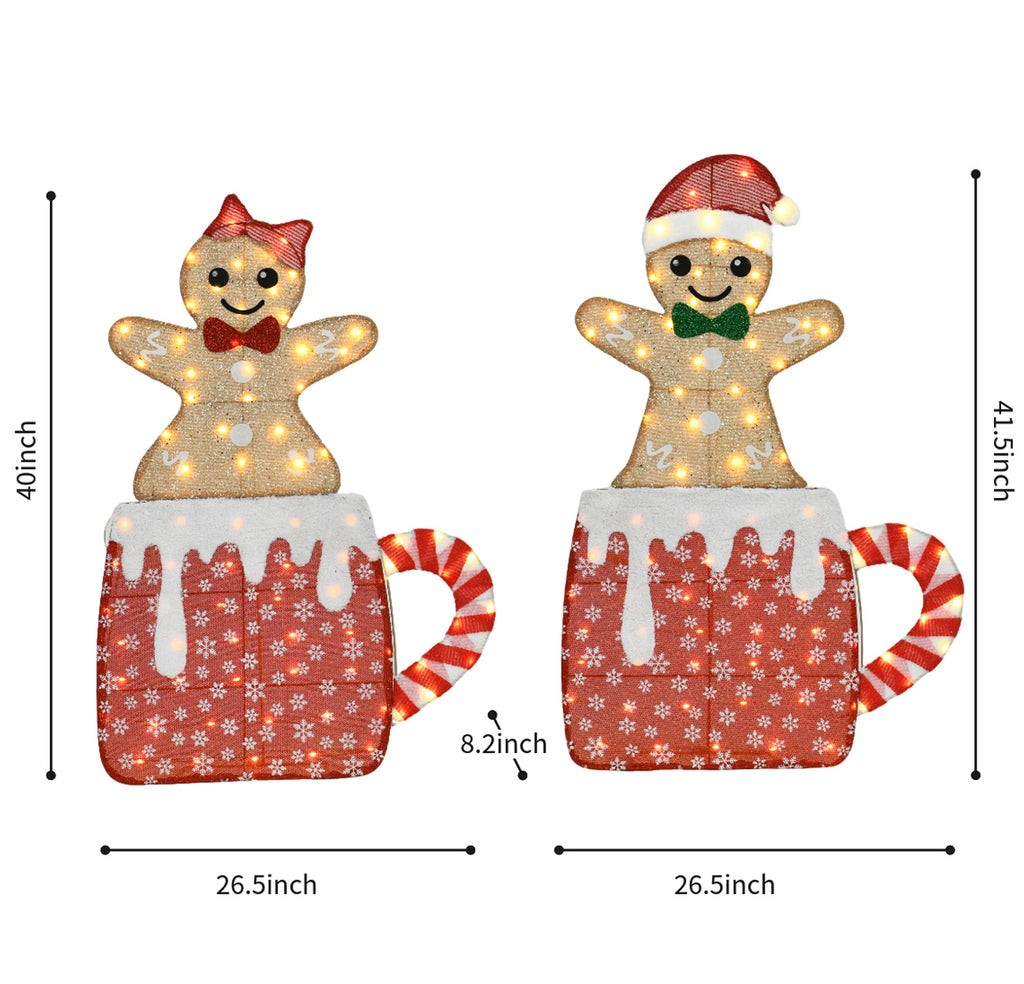 40" Set of 2 lighted 2D tinsel gingerbread couple decorations, featuring cute gingerbread figures sitting inside festive Christmas mugs, plug-in powered with warm glowing lights.